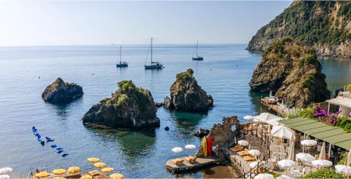 a view of the ocean with boats in the water at Gardenia Mare Apartments in Ischia Town