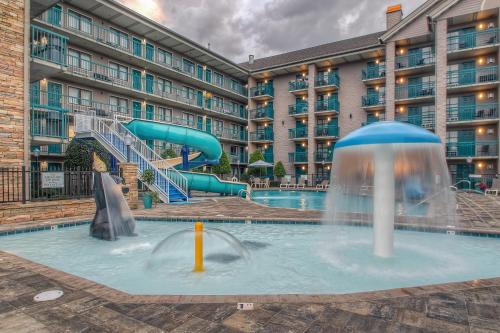 a pool at a hotel with a water slide at Accommodations By Willow Brook Lodge in Pigeon Forge