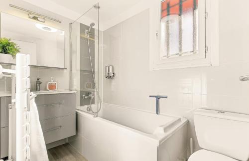 a white bathroom with a sink and a toilet at Chalet de Seyne in Seyne