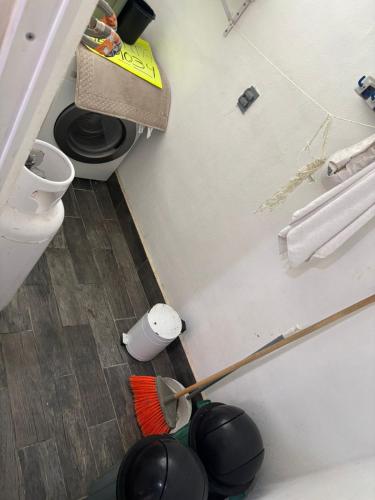 a bathroom with a toilet and a toilet brush at Majos Aldea Tulum in Tulum