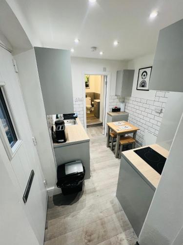 a kitchen with white cabinets and a counter top at Yastayzzz Studio 2 Worcester House with Free Parking in Worcester