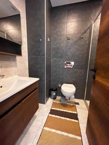a bathroom with a toilet and a sink at Serenity Residence apartment in Alanya
