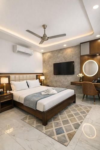 a bedroom with a bed and a flat screen tv at Hotel MDP Ayodhya Near Rammandir Ayodhya in Ayodhya