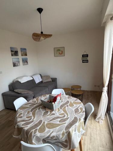 a living room with a table and a couch at appartement à Sainte Cecile in Camiers