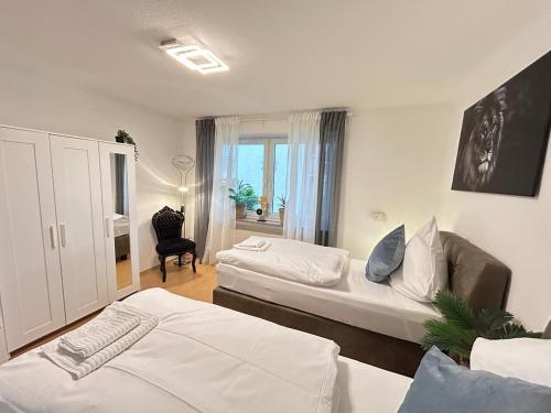 a hotel room with two beds and a living room at Fewo am Disselhook in Lüdinghausen