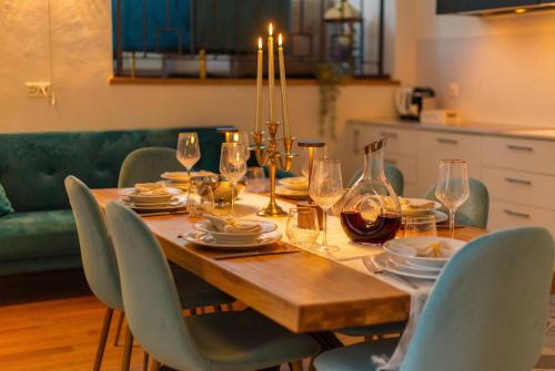 a dining room table with plates and wine glasses at The Queens House in Bellinzona