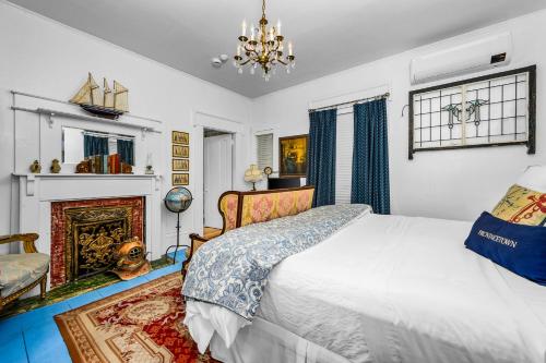 a bedroom with a bed and a fireplace at The Gaslamp Bed and Breakfast in Provincetown