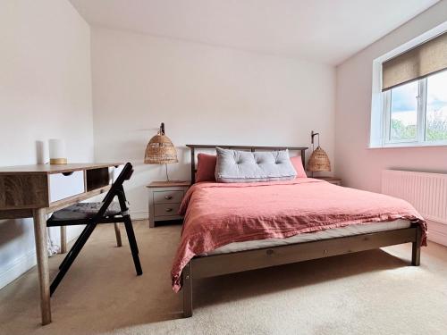 a bedroom with a bed and a desk and a window at Guest Rooms Apsley Lock in Hemel Hempstead