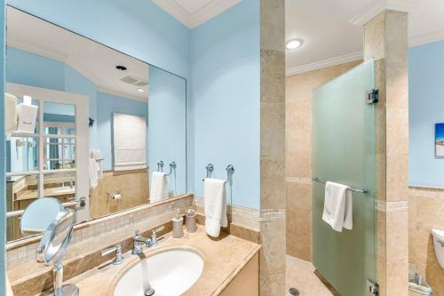 a bathroom with a sink and a mirror at 101 Sapphire Beach Barbados in Christ Church