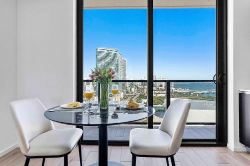 a dining room with a table and chairs with a view at Downtown by Miami Vacation Rentals in Miami