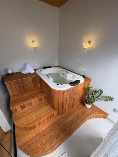 a jacuzzi tub in a room with two lights at Pousada Encantos do Estaleiro in Balneário Camboriú