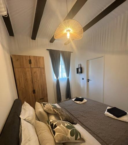 a bedroom with a bed and a chandelier at One Bedroom Apartment with Terrace in Oradea