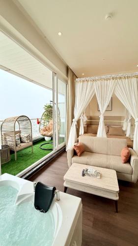 a bedroom with a bed and a couch and a table at Sundowner Hive115 Jacuzzi studio Large grdan patio in Gurgaon