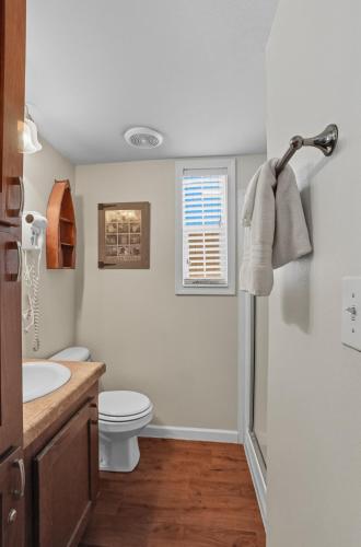 a bathroom with a toilet and a sink at Live Oak Landing in Freeport