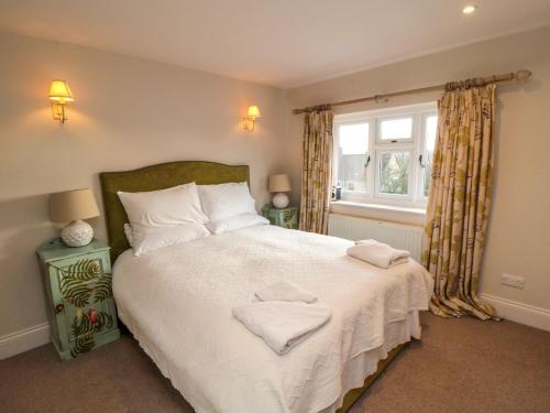 a bedroom with a bed with two towels on it at St Anthonys in York