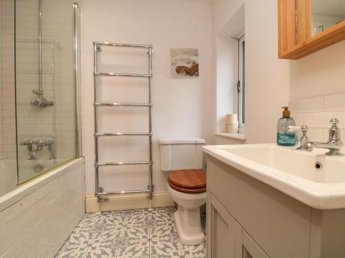 a bathroom with a toilet and a sink and a shower at St Anthonys in York