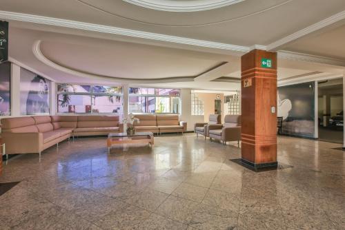 a lobby with couches and tables in a building at Hot Star Thermas Hotel in Caldas Novas