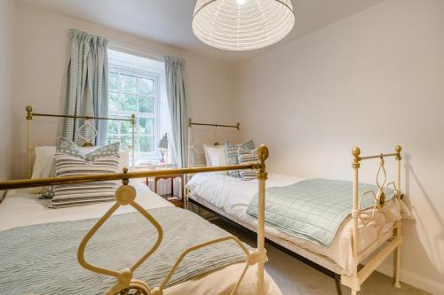 a bedroom with two beds and a chandelier at 2 Bed in Brough oc-c31900 in Brough