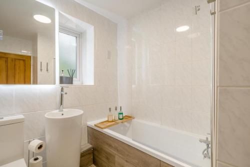 a white bathroom with a tub and a shower at 2 Bed in Brough oc-c31900 in Brough