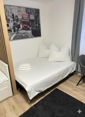 a bed in a room with a picture on the wall at Modern Compact Studio near Frankfurt in Karben