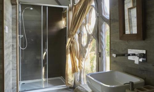 a bathroom with a shower and a sink and a tub at Glastonbury tranquility in Glastonbury