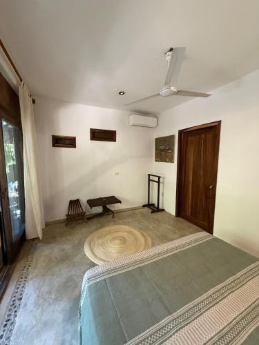 a room with a bed and a table in it at Green oasis across from the main street in Mazunte