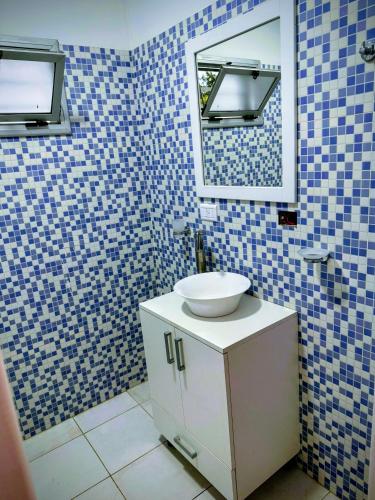 a bathroom with a sink and a mirror at Los Adobes in Cerrillos