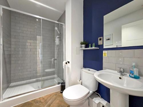 a bathroom with a toilet and a sink and a shower at The Post House One by Fortuna Property Portfolio in Gloucester