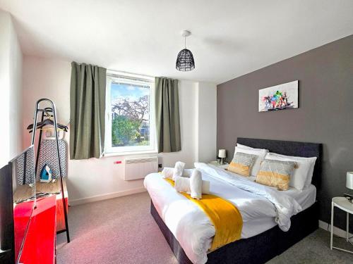 a bedroom with a large bed and a window at The Post House One by Fortuna Property Portfolio in Gloucester