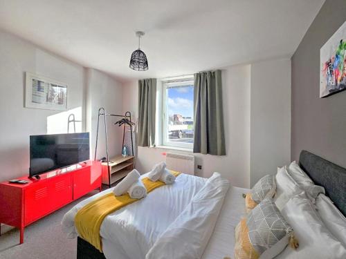 a bedroom with a bed and a flat screen tv at The Post House One by Fortuna Property Portfolio in Gloucester