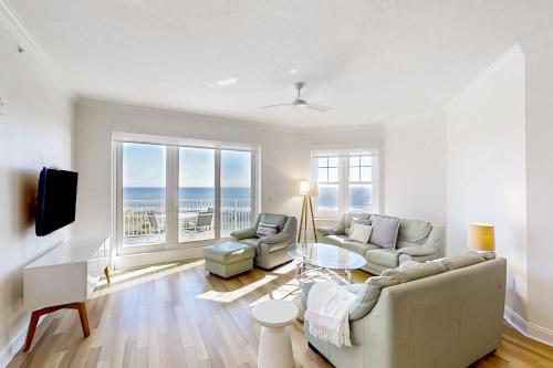 a living room with a couch and a table at Beautiful Oceanfront Getaway w/Shared Pool, Central AC, Elevator, & W/D in Fernandina Beach