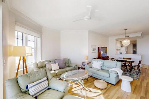 a living room with a couch and a table at Beautiful Oceanfront Getaway w/Shared Pool, Central AC, Elevator, & W/D in Fernandina Beach