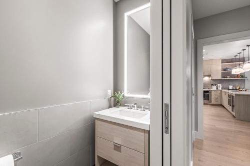 a white bathroom with a sink and a mirror at Abode at Deer Valley East in Park City