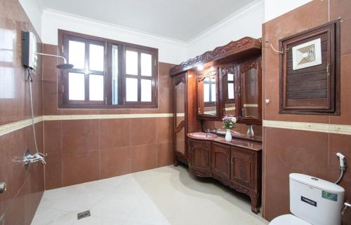 a bathroom with a toilet and a sink and a mirror at Private pool Villa3rooms in Siem Reap