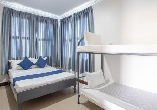 a bedroom with two bunk beds and a window at Private pool Villa3rooms in Siem Reap