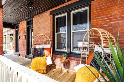 a porch with two chairs and two windows at Jungle House Luxury Stays - Columbus Downtown Short North in Columbus