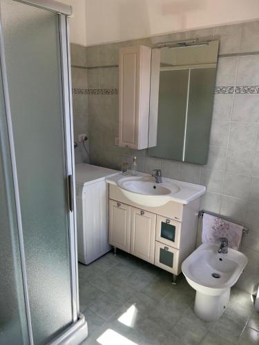 a bathroom with a sink and a toilet and a mirror at B&b DALLA FE in Fermignano