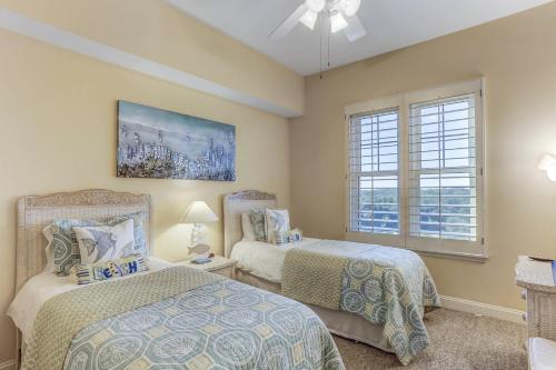 a bedroom with two beds and a window at Oceanfront 5th-floor condo with balcony, gorgeous views & pool access in Fernandina Beach