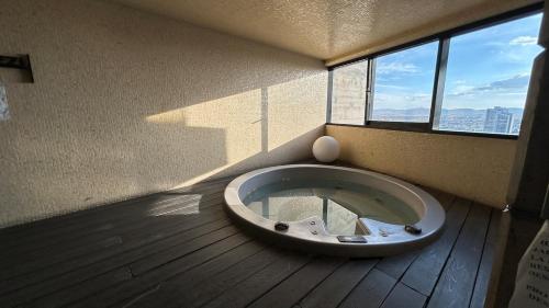 a room with a large bowl in a room with windows at Modern apartment in Angelopolis - 2 bedrooms in Tlazcalancingo