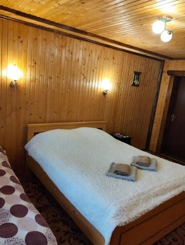 a bedroom with a bed with two towels on it at У Матвія in Vorokhta