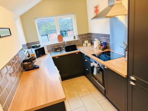 a kitchen with wooden counters and a counter top at Cecil House, Stylish 2 Bed, Sleeps 5, Close to Cathedral & Castle, ideal for groups or Families, Parking x2 in Lincoln