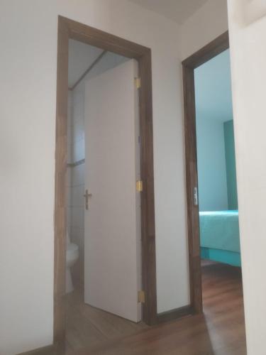 an open door in a room with a bathroom at Cabañas Drü 3 in Coihaique
