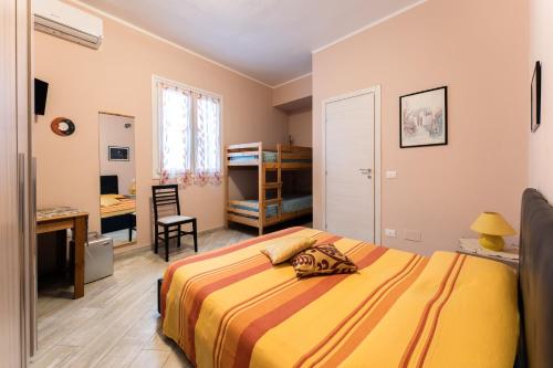 a bedroom with a bed and a desk and a desk at tra il borgo e il mare in Cervo