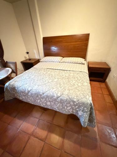 a bedroom with a bed with a wooden headboard at The Cabo Cush Hotel in Cabo San Lucas