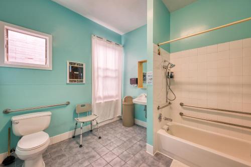 a bathroom with a toilet and a tub and a sink at HI San Francisco Downtown Hostel in San Francisco