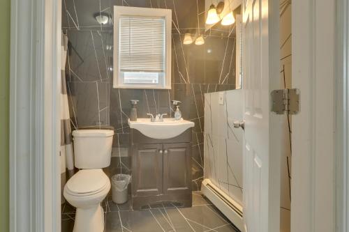 a bathroom with a toilet and a sink at Explore NYC, Parks & Beaches! Top-Floor Apt in Mount Vernon