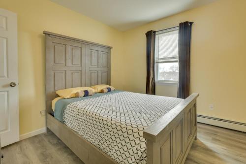 a bedroom with a bed and a large window at Explore NYC, Parks & Beaches! Top-Floor Apt in Mount Vernon