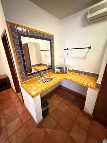 a bathroom with a sink and a mirror at The Cabo Cush Hotel in Cabo San Lucas