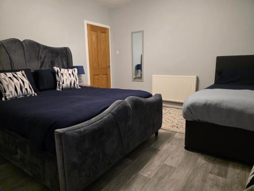 a bedroom with a couch next to a bed at Wick Harbour View Apartment - 2 Beds - Sleeps 3 - Ideal for Couples in Wick