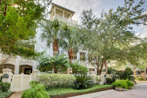 a white house with palm trees in front of it at Beach cottage with private pool & spa, ocean views, & shared pool access in Saint Simons Island